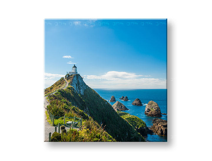 În stil boho tablou pe pânză cu motivul KRAJINA, far, ocean, cer, mare și plajă în alb-albastru nuanțe, atmosferă liniștită, potrivit pentru birou – principală